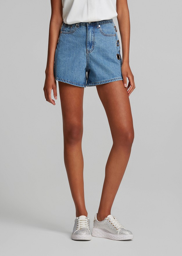 Denim shorts featuring metallic circle details