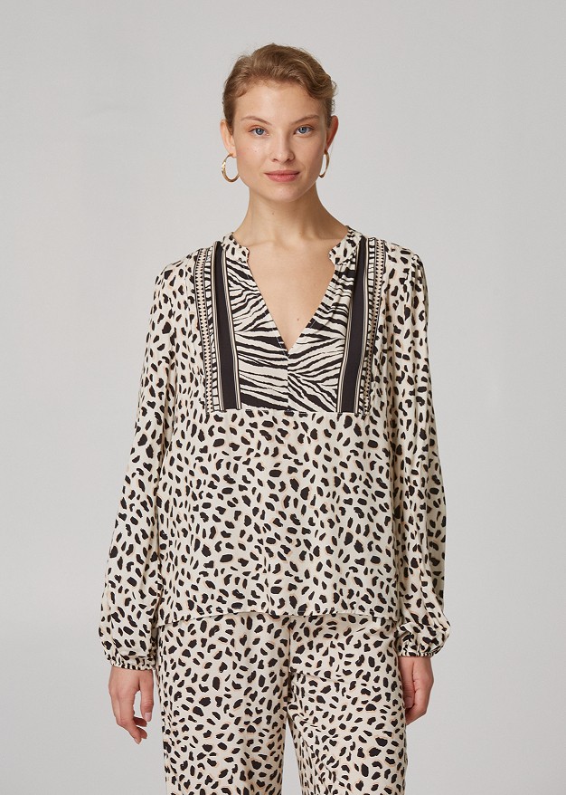 Animal print blouse with decorative border