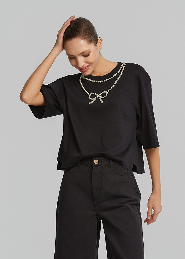 Crop top with a pearl-adorned bow detail