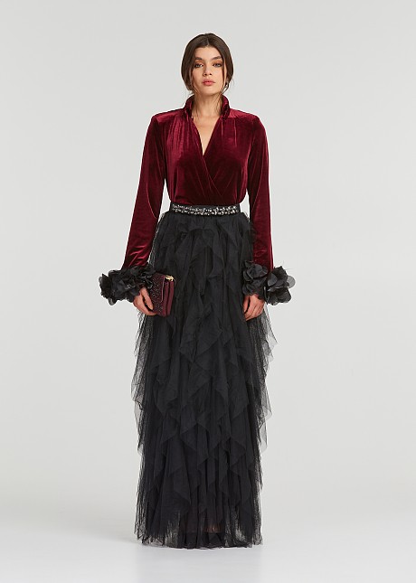 A blouse with a velvet look and feathered cuffs