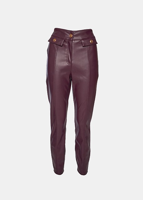 Pants in leather look with decorative pockets