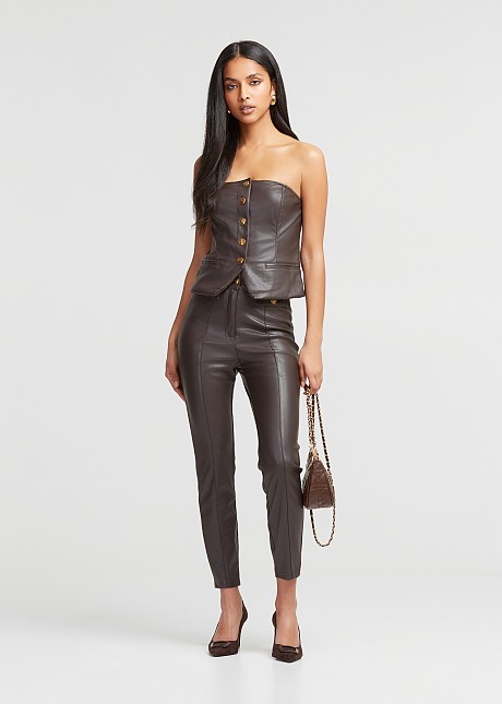 Pants in leather look with decorative pockets