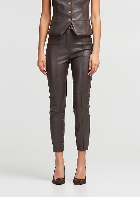 Pants in leather look with decorative pockets