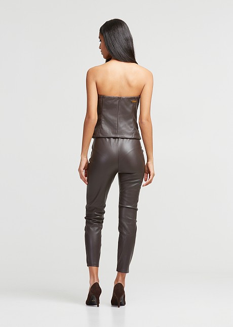 Pants in leather look with decorative pockets