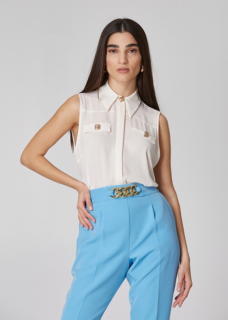 Sleeveless blouse with gold square buttons