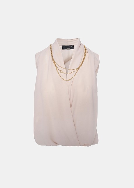 Sleeveless blouse with decorative necklace