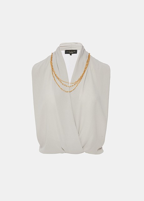 Sleeveless blouse with decorative necklace