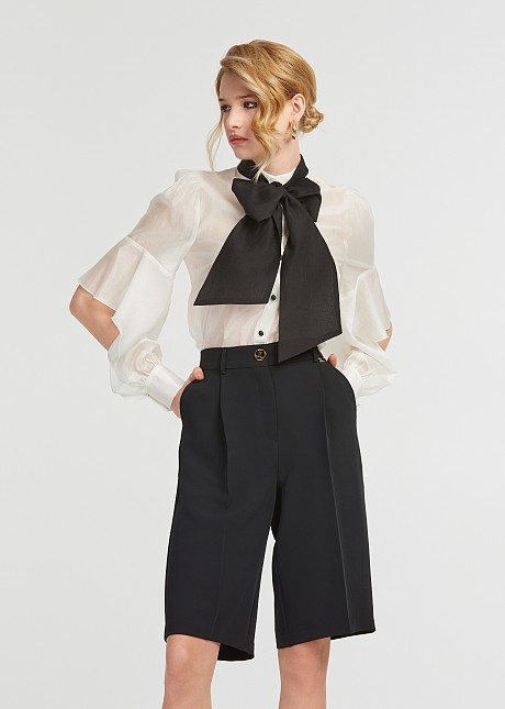 Shirt with a bow and cut on the sleeves