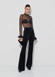 Sheer top with decorative feathers