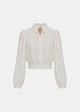 Blouse in statement shoulders and brooch