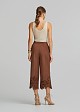 Soft suede-look finish pants and laser-cut accents